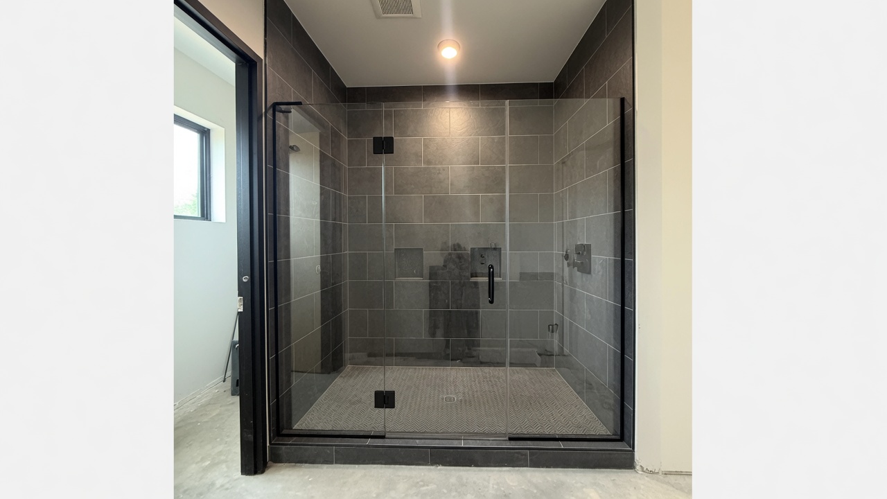 Frameless glass shower installation in a modern master bath
